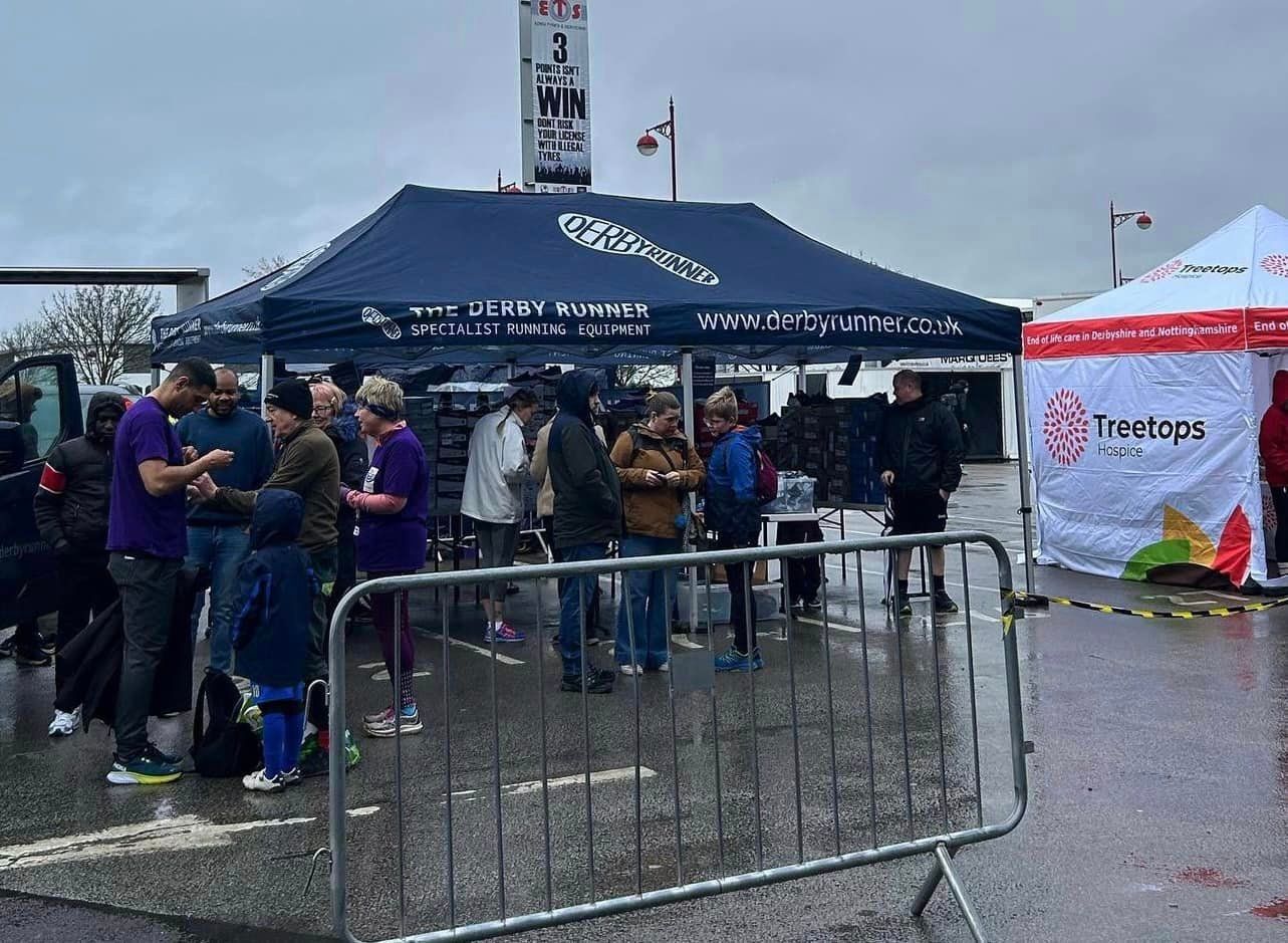 A printed gazebo providing shelter at a rainy outdoor event