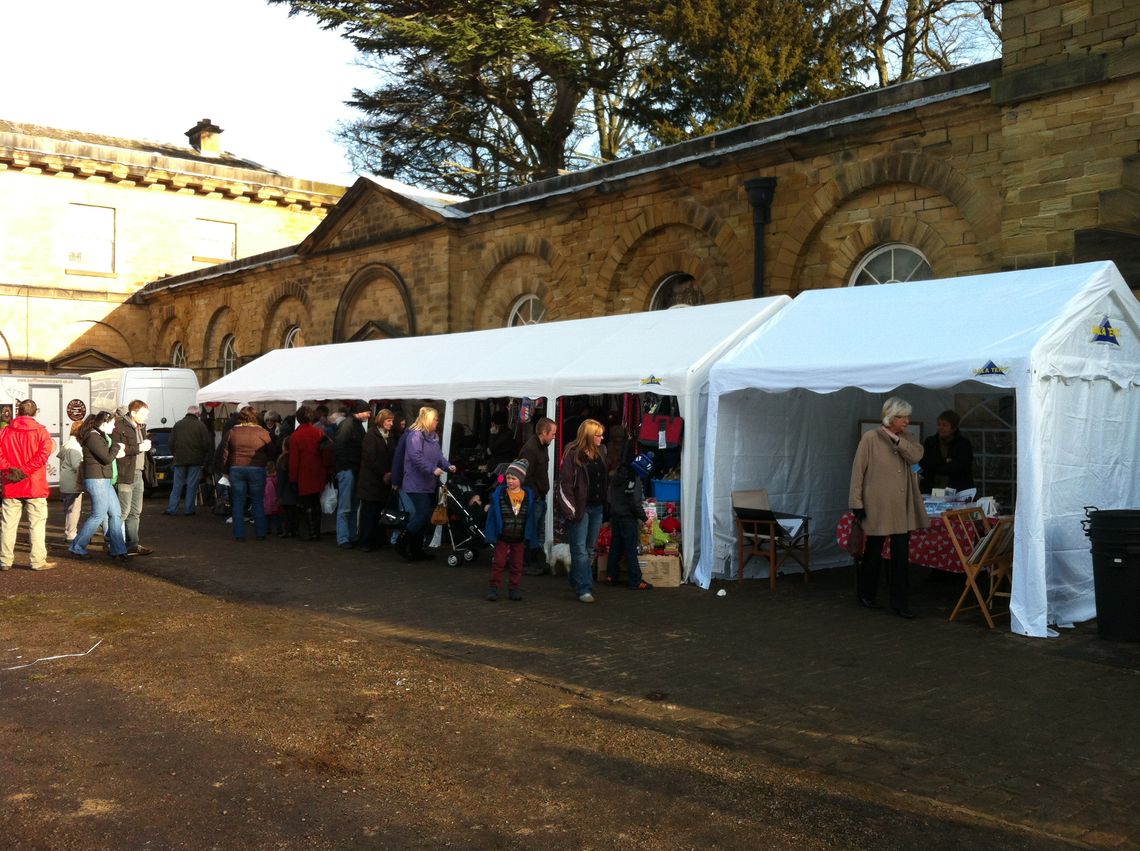 A row of marquees being used as trade stalls