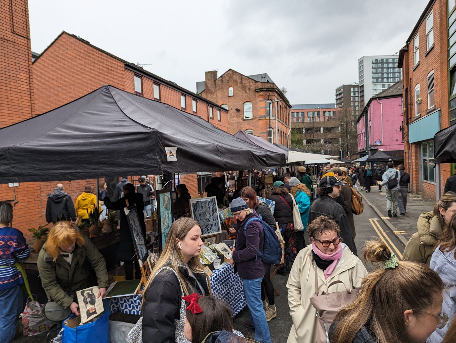 Two Manchester Markets black pop up gazebo stalls in action