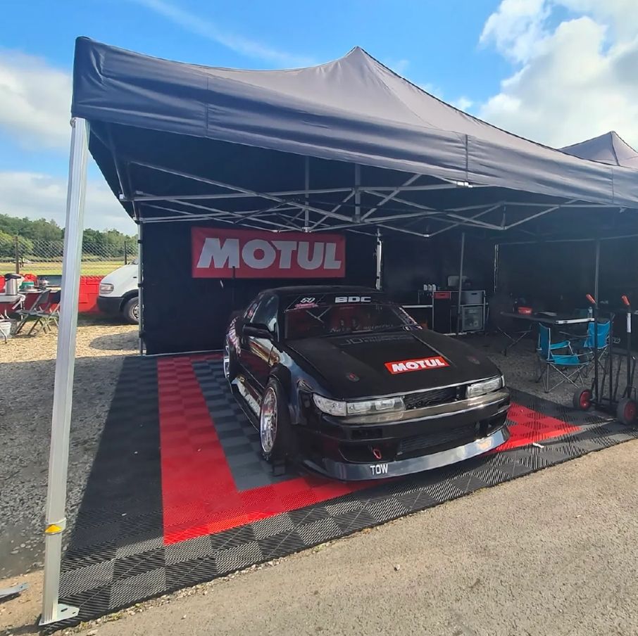 Multi-coloured swisstrax flooring tiles beneath a Gala Shade Gazebo