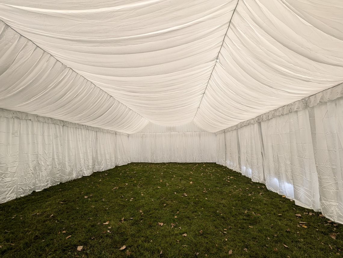 Elegant white satin lining inside a large marquee