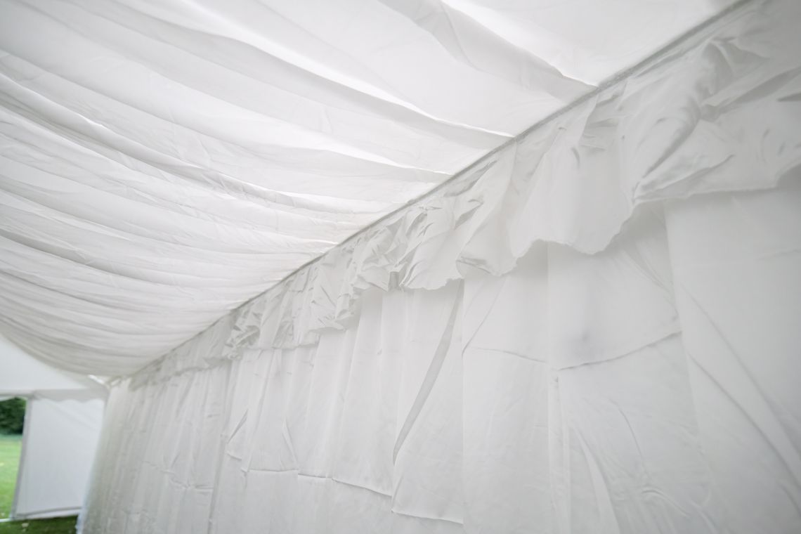 White marquee lining inside a marquee