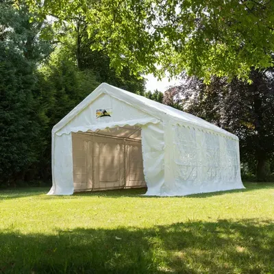 A 4m x 6m Marquee erected in a green space with trees surrounding it