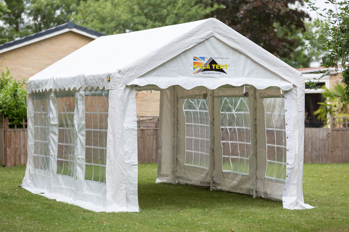 A 3m x 6m marquee in a garden, with house buildings behind it