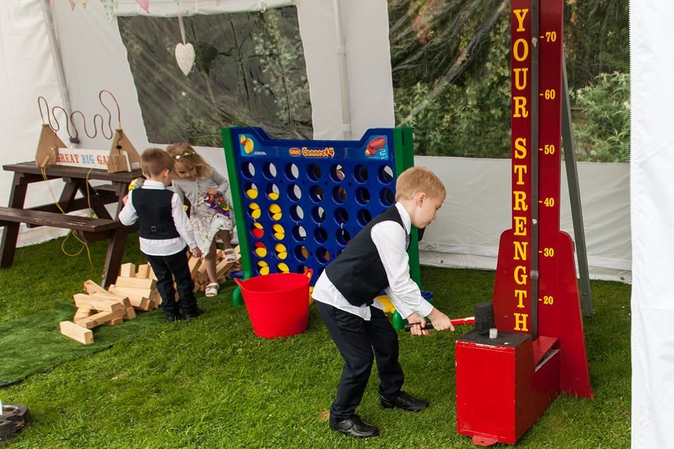 Children play games at a wedding in a marquee