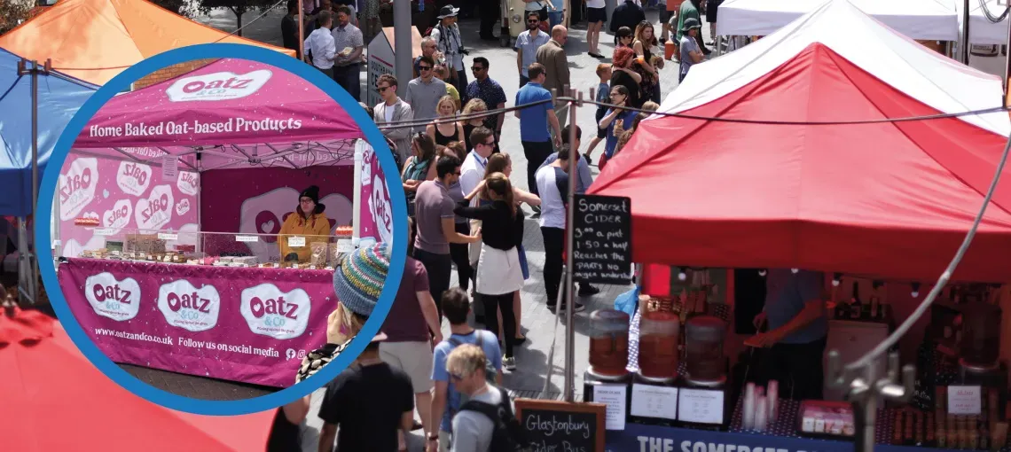 A busy street food market, with an inlay image of a cookie seller