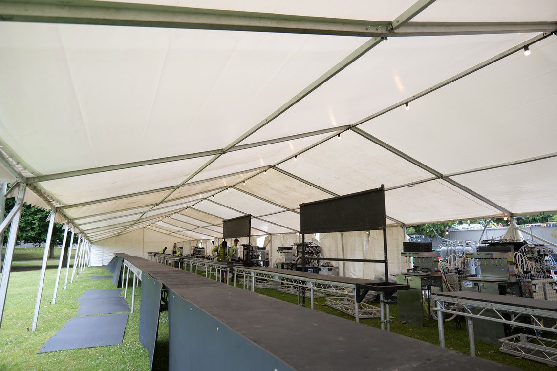 A bar tent at a music festival being set up