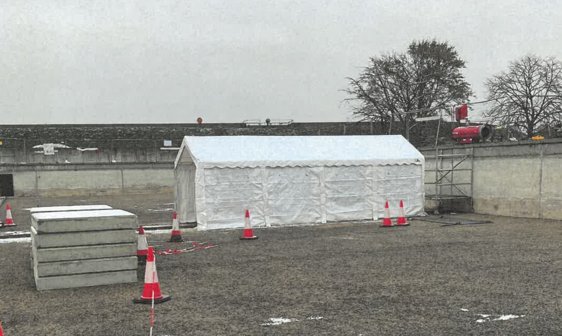 A small storage tent on a work yard