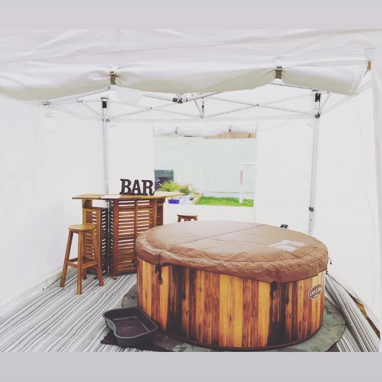 Hot tub and mobile bar inside a white gazebo