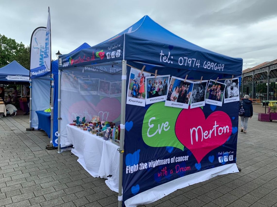 Charity stall under a promotional shelter