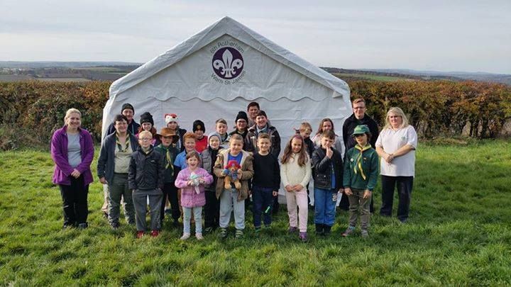 Young Scouts in front of a branded marquee