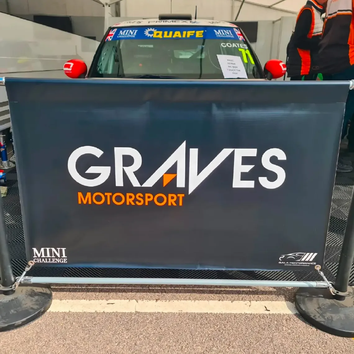 A Black cafe barrier printed with Graves Motorsport on it