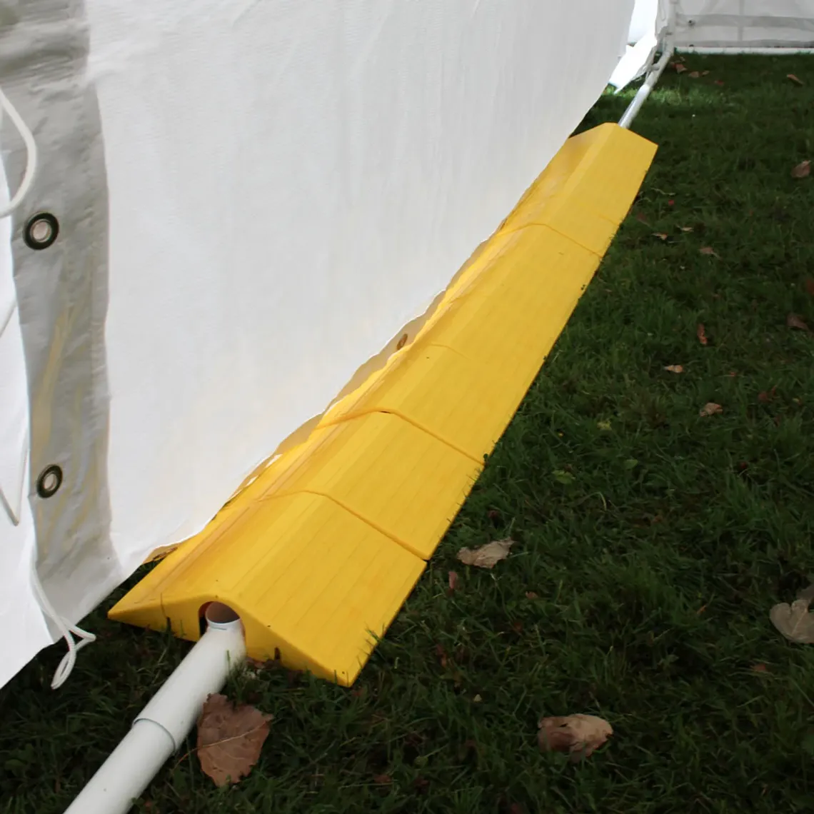 A bright yellow safety ramp across marquee ground bars