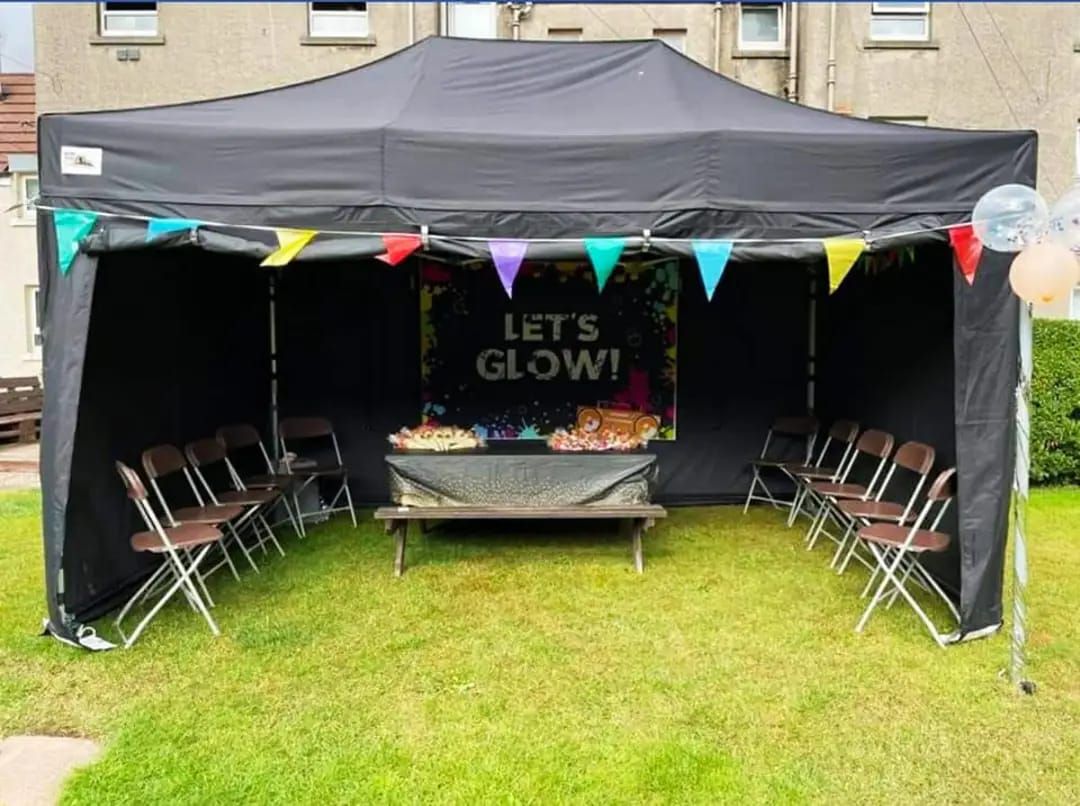 Black mini marquee in a garden