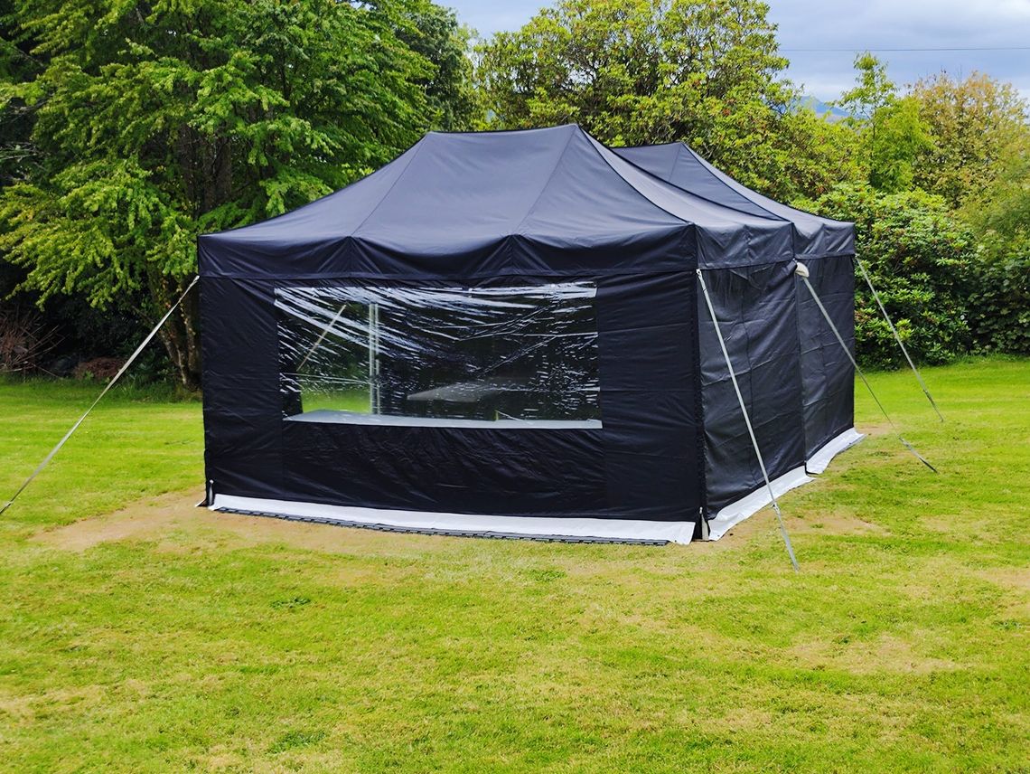 Black mini marquees with black sidewalls in a field