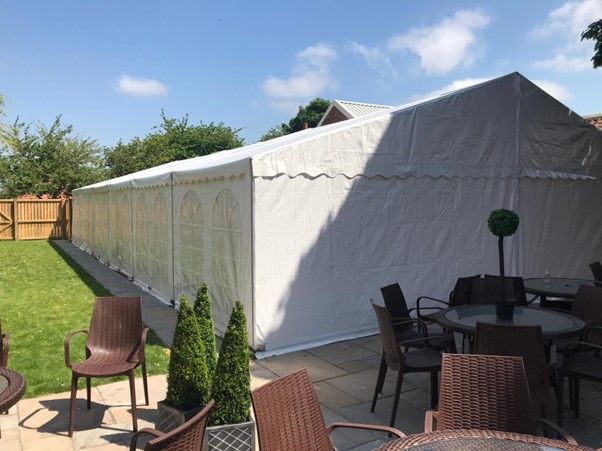 Large beer garden with a heavy duty marquee in it on the grass