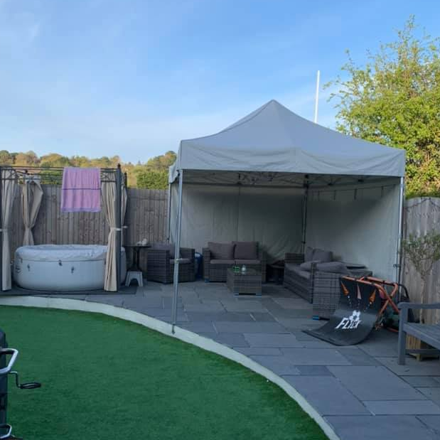 A taupe gazebo over rattan furniture