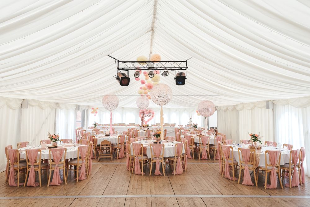 A large marquee wedding set up with wooden flooring