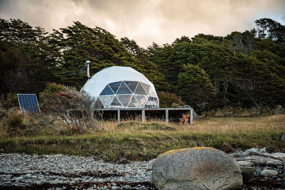 A geodesic glamping dome with a solar panel for energy