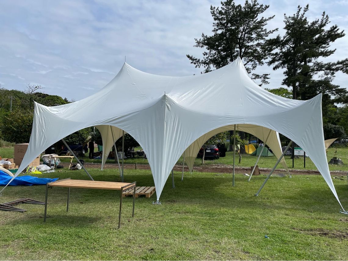 A small capri stretch tent erected in a field