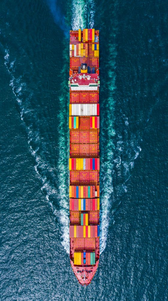 An overhead shot of a container ship on the water