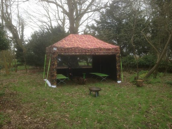 large sports gazebo with camouflage design as a fishing bothy