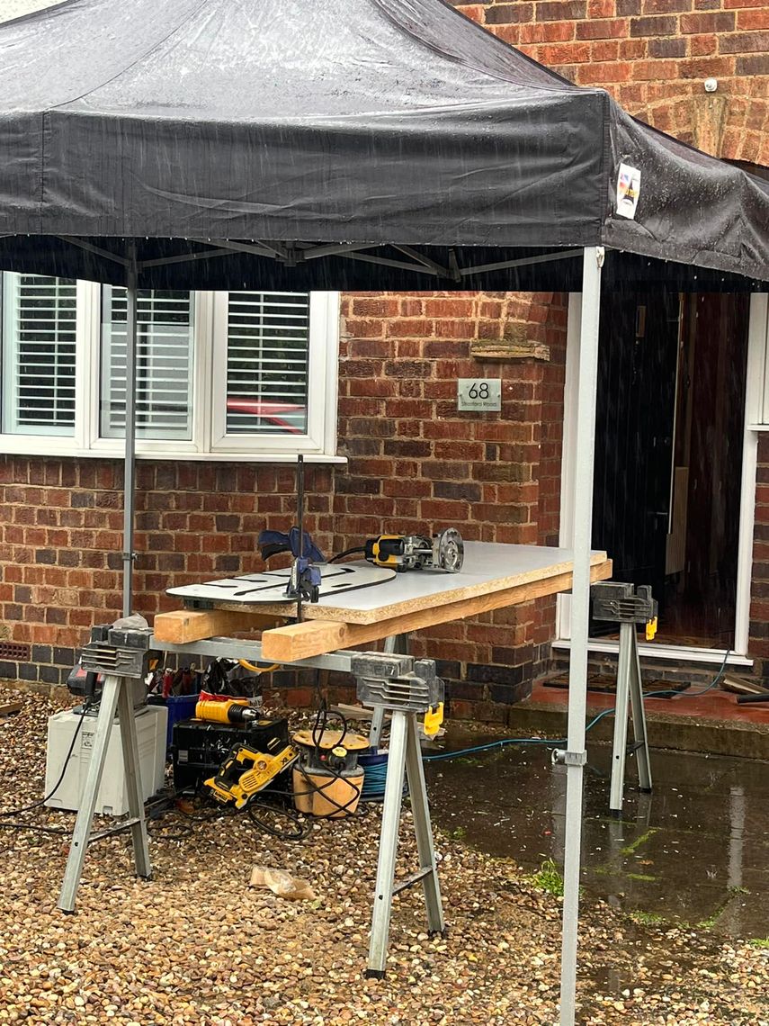 A waterproof work shelter protecting equipment from the rain